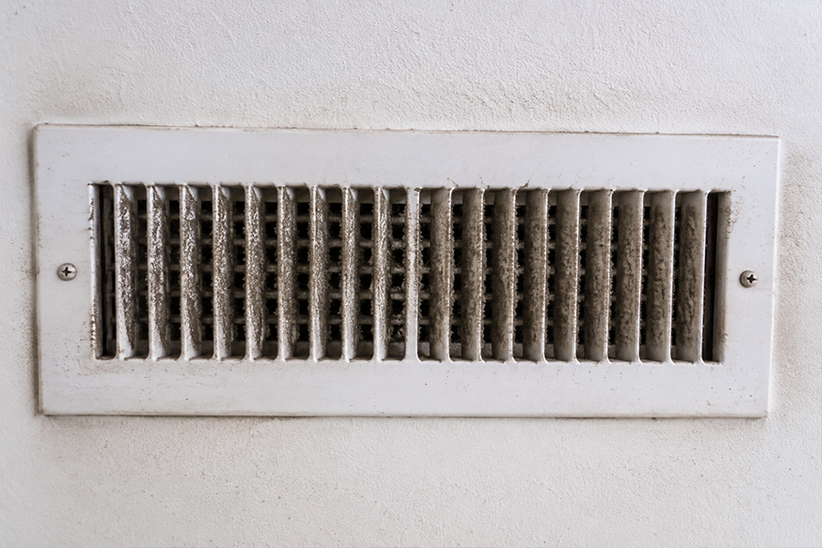 Dirty air vent with visible dust and buildup inside HVAC vent grille